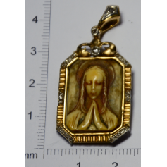 Medal with image of virgin carved in ivory, and gold.