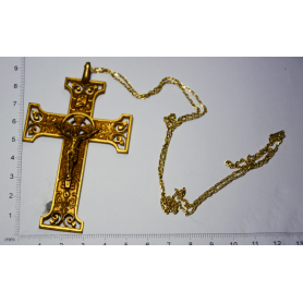 Large cross hanging on gold metal chain in gold.